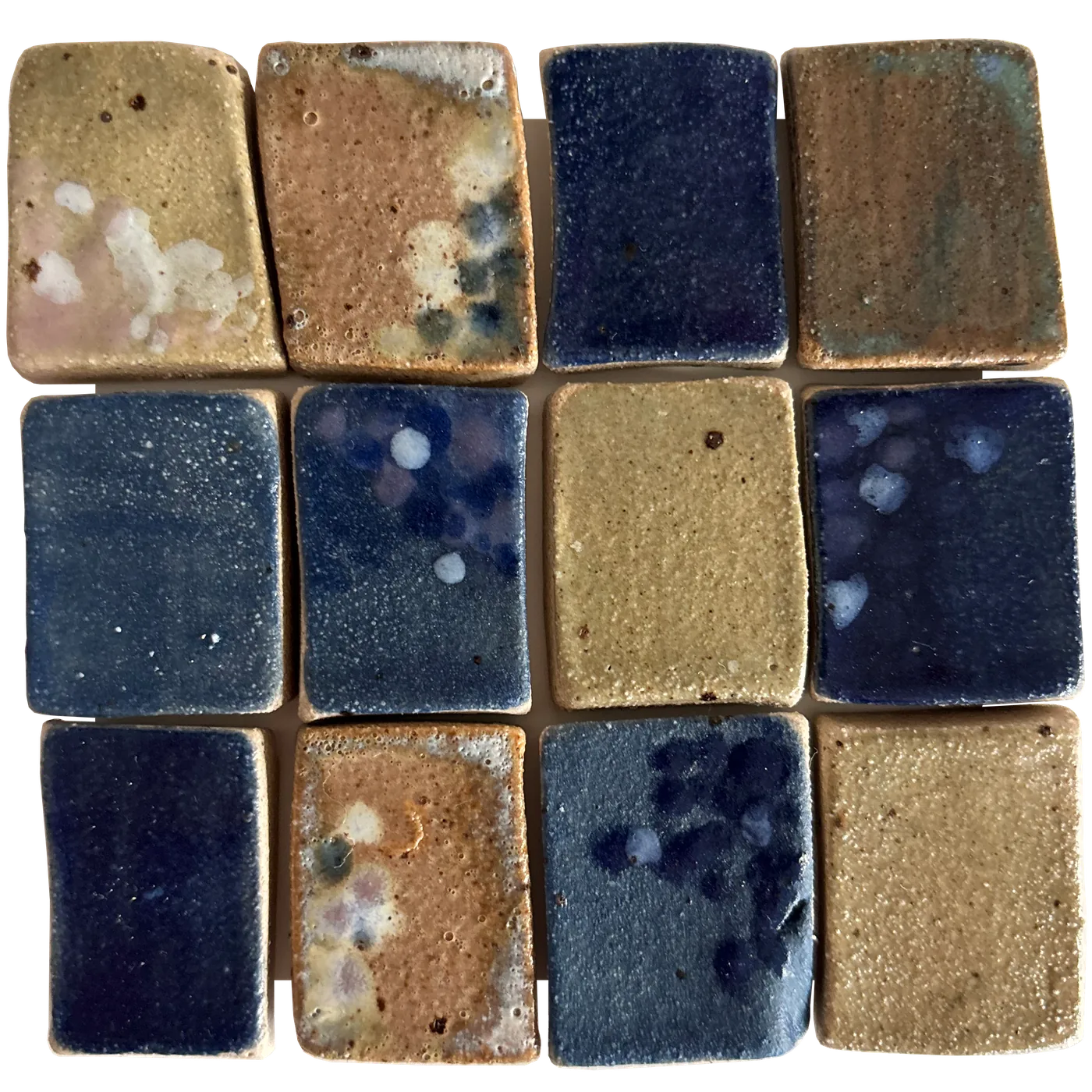 Ceramic tiles in blue and ochre glazes by Nordisk Studio